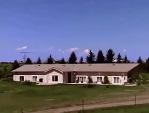 Peaceful suburban house suddenly exploding into a giant fireball